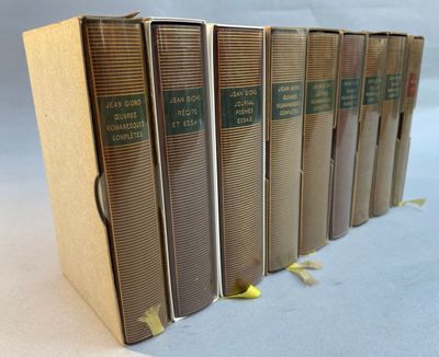 six books are lined up in a row on a white surface
