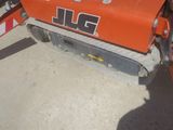a small orange machine that is sitting on the ground