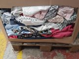 a box full of clothes sitting on top of a pallet
