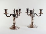 pair of silver plated candlesticks on a white background