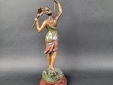 an image of a statue of a woman holding a golf club