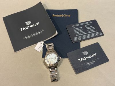 the tagless watch is sitting on the table next to the business card