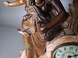 a statue of a woman sitting on top of a clock
