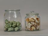 two glass jars with different types of food in them