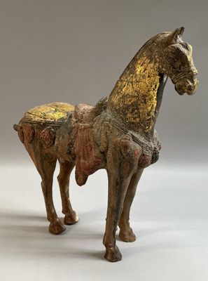 a statue of a horse that is standing on a white surface
