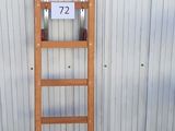 une échelle en bois appuyée contre un mur, sur laquelle figure un numéro
