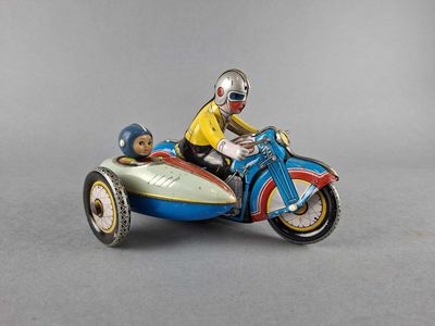 a figurine of a man riding a motorcycle with a dog on it