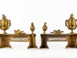 two gold vases and a table with a bird on it