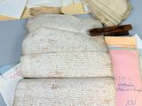 several old papers are piled on top of each other on a table