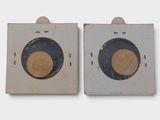 two pieces of wood with a gold coin on them