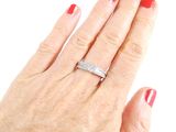 a woman ' s hand with a diamond ring on it