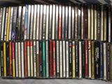 a box full of various cd ' s sitting on a bed
