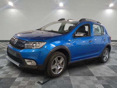 a picture of a blue dacia parked on a checkered floor