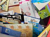 many different types of stamps and envelopes in a box
