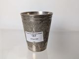a silver cup with a label on it sitting on a table