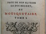 un vieux livre posé sur une table à côté d'une tasse de café