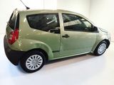 a small green car that is parked in a room