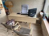 a desk with a chair and a computer on it