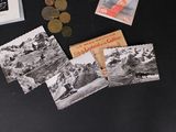 a black table with a bunch of cards and coins on it