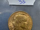 a close up of a gold coin with a label on it