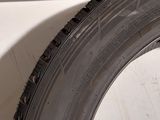 a tire on the side of a car with a hole in it