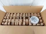 a cardboard box filled with wooden blocks and a plastic bowl