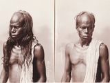 an old black and white photo of a man with no shirt on