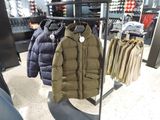 several jackets hanging on a rack in a store