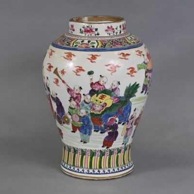 a vase with a painting on it sitting on a table