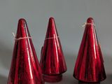 several red cones are lined up in a row on a white surface