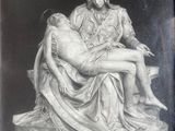 an old photo of a statue of a woman holding a baby