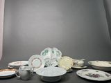 a lot of plates and cups sitting on a table