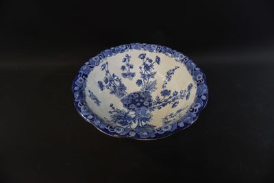 a blue and white bowl sitting on a black table