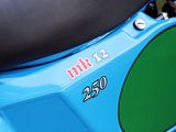 a close up of a blue motorcycle with a black seat