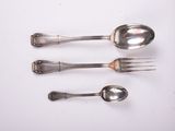 three silver spoons and a fork on a white surface