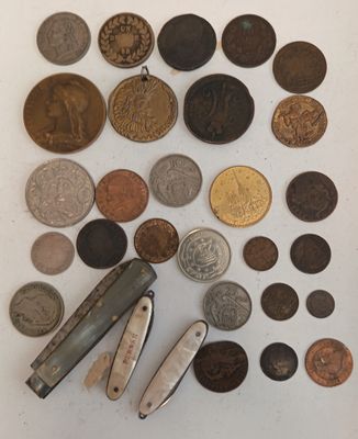 beaucoup de pièces de monnaie et un couteau de poche sur la table