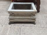 a planter on the floor in the middle of the room