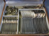 silverware in a wooden box on a table with silverware in it