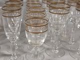 many wine glasses lined up on a table