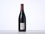 a bottle of red wine sitting on top of a table
