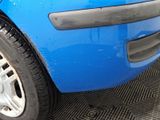 a close up of a car ' s front bumper and tire