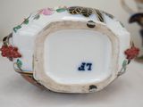 a close up of a decorative vase on a table