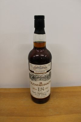 a bottle of liquor sitting on a wooden table