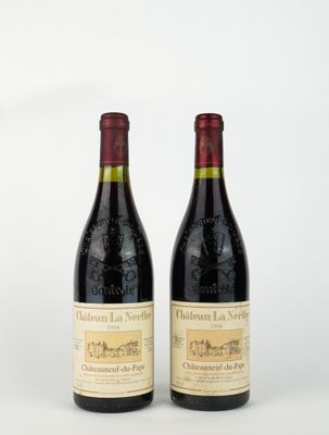 two bottles of red wine sitting next to each other on a white surface