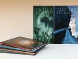 trois livres sont empilés sur une table