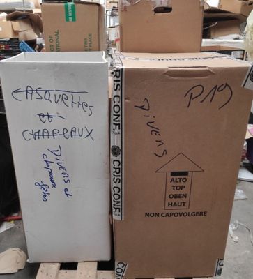 two boxes sitting on a pallet with writing on them