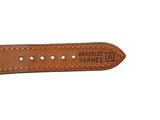 a close up of a brown leather watch strap on a white background