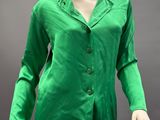 an image of a mannequin wearing a green shirt and beige pants