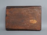 an old wooden box sitting on top of a gray surface
