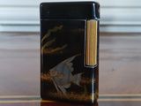 a black lighter sitting on a wooden table